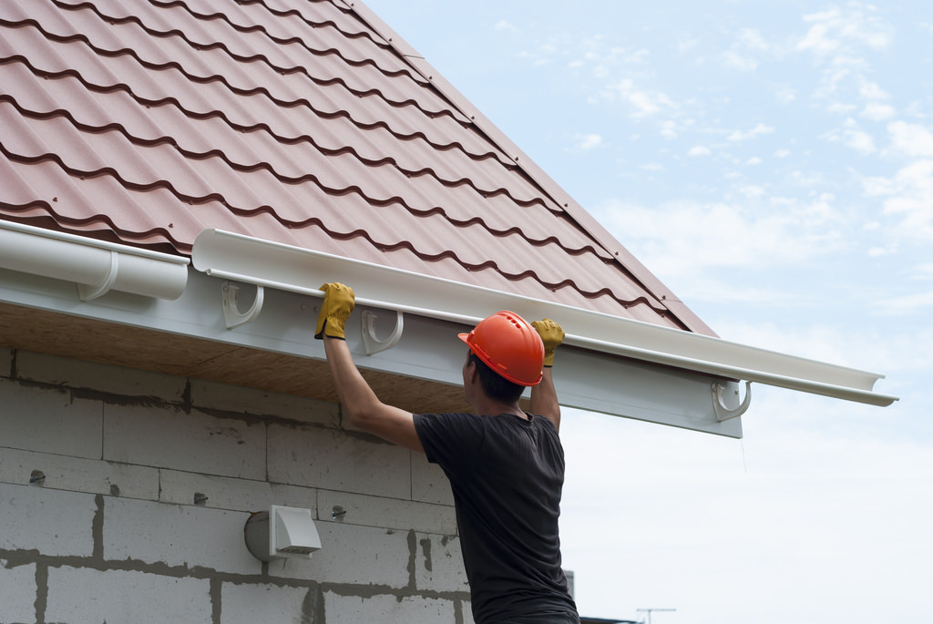 Roofing Contractor Installing Gutter System