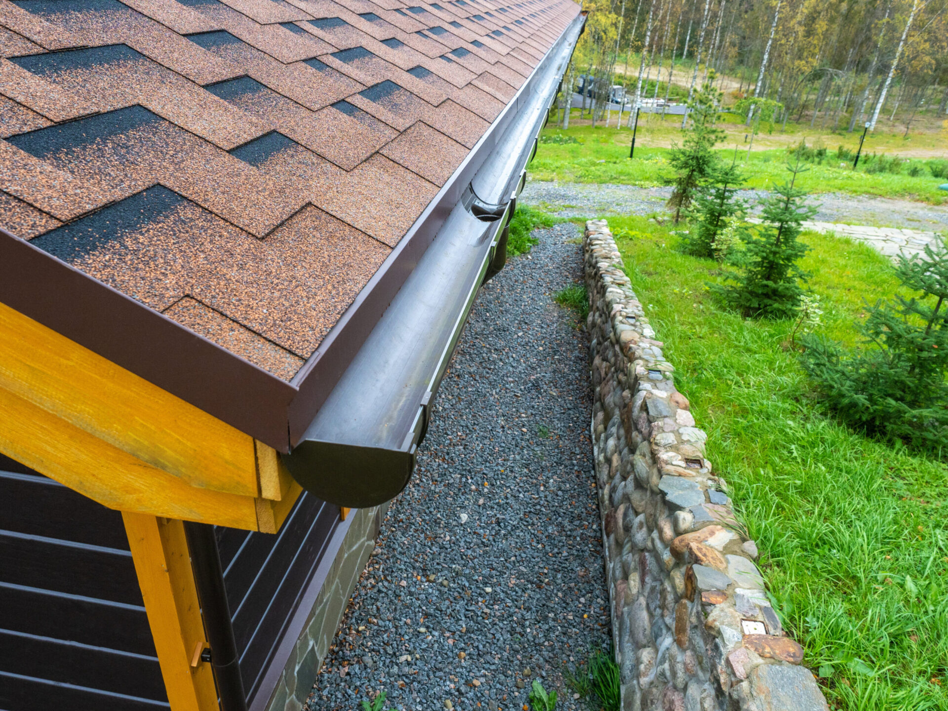 Holder gutter drainage system on the roof. Drain on the roof of the house. Roof drainage. Water drainage from the roof.