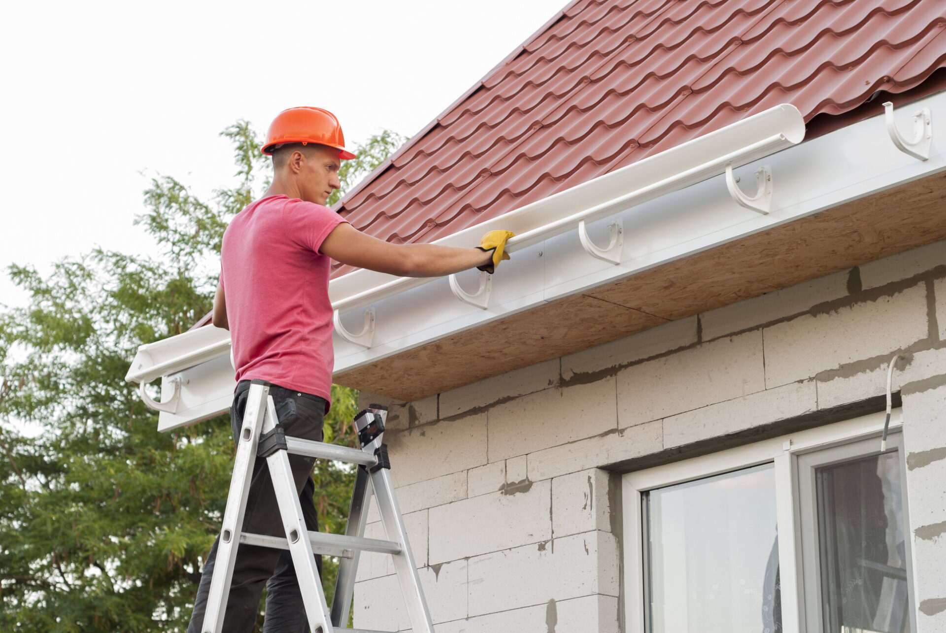 professional contractor installing gutter section in the bracket