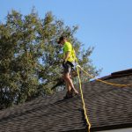 a man inspecting a roof