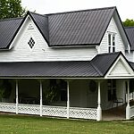 Large white house with black roof