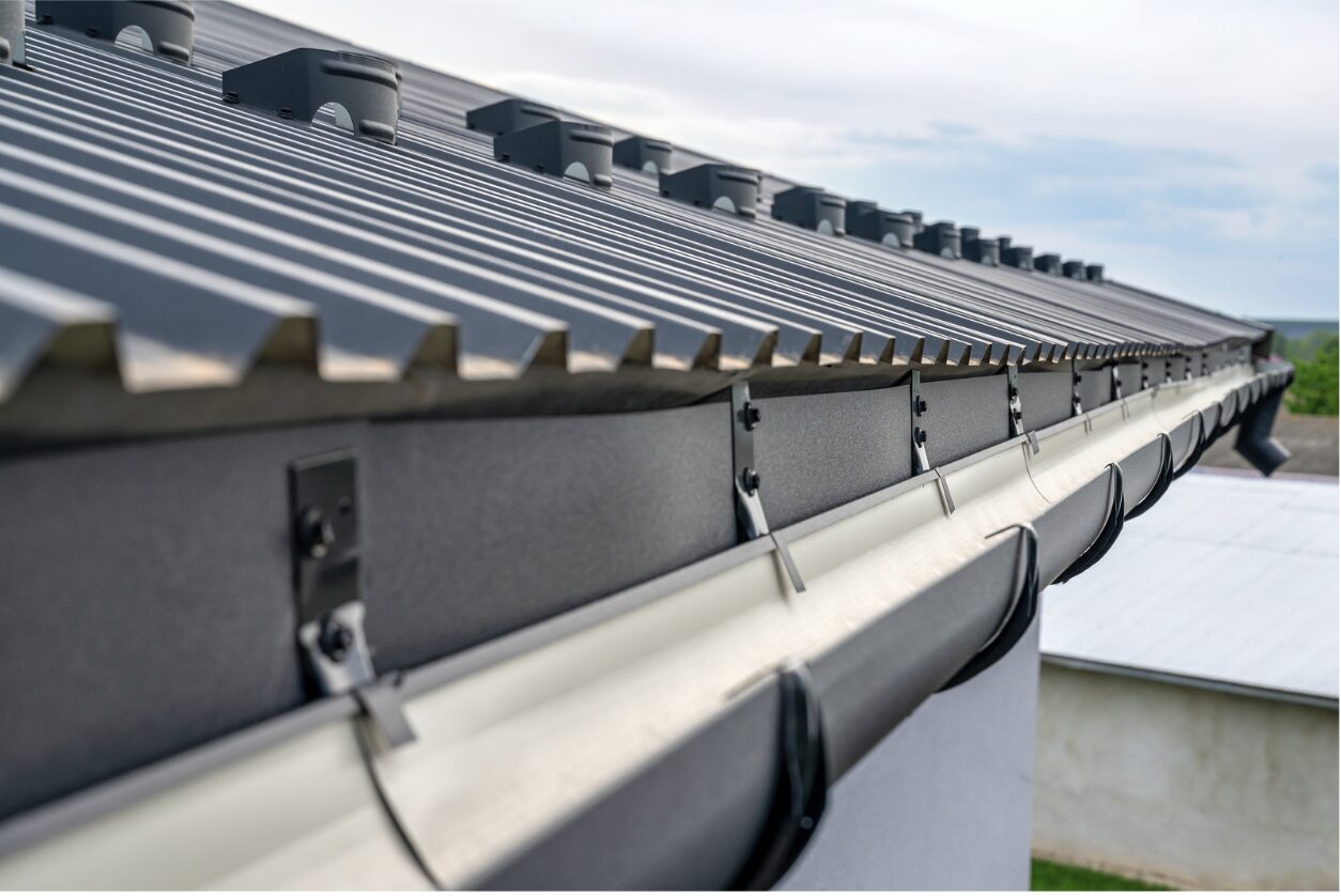 Newly installed gutter in a metal roof