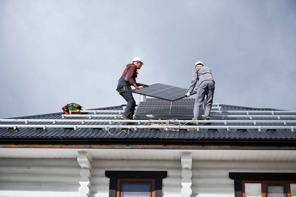 technicians installing a solar panel