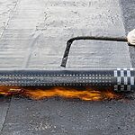 work-on-waterproofing-the-roof-of-a-multi-storey