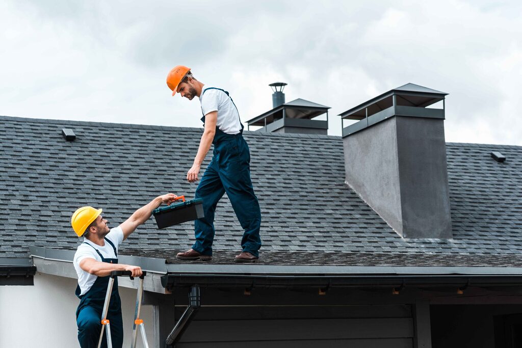 handyman-in-helmet-giving-toolbox