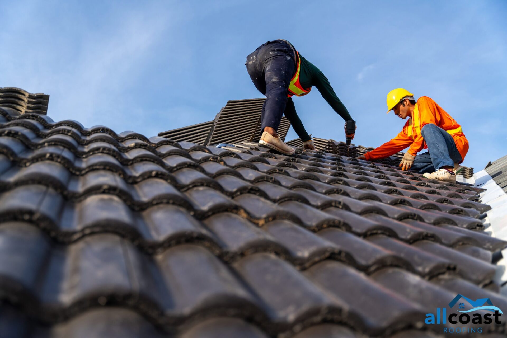 two roof worker repairing a roof