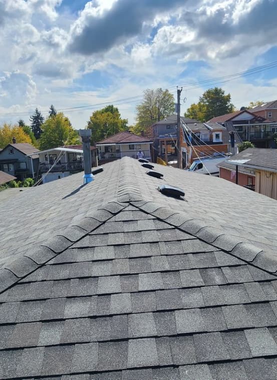 Detail of flashing and exhaust integration on pitched roof — All Coast Roofing